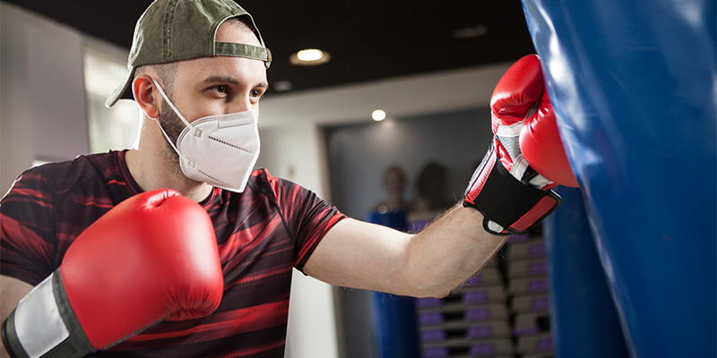 Man boxing with face mask on